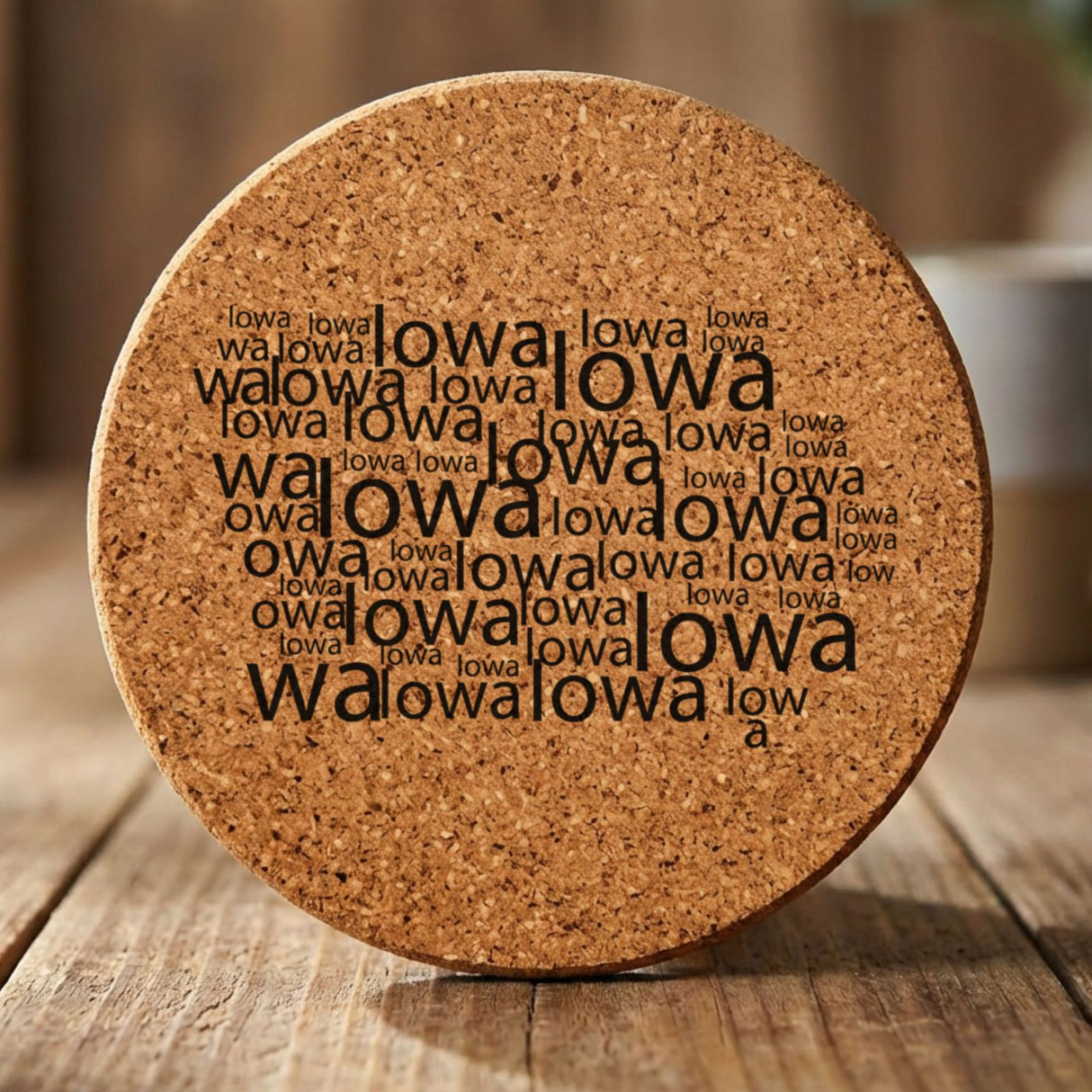 Iowa round cork coaster engraved with a word cloud of repeating Iowa text