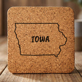 Iowa square cork coaster engraved with the state outline and IOWA in hand-drawn brush lettering