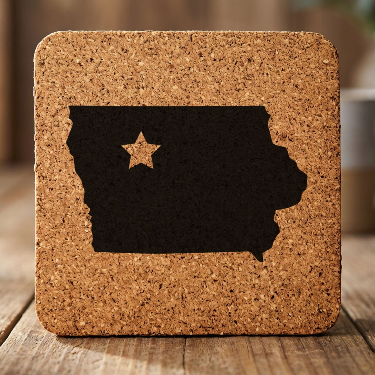 Iowa square cork coaster engraved with the state shape and a star