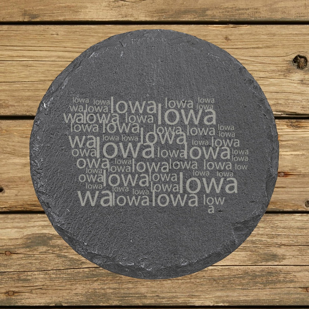 Iowa round slate coaster engraved with a word cloud of repeating Iowa text