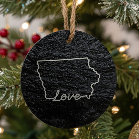 Iowa round slate Christmas ornament engraved with a hand-drawn state outline and love in cursive