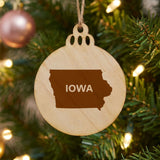 Iowa round wood Christmas ornament engraved with the state shape and IOWA in bold lettering