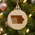 Iowa round wood Christmas ornament engraved with the state shape in ornate floral scrollwork
