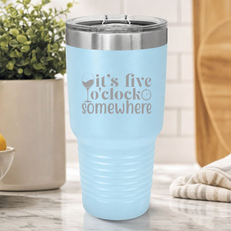 Light Blue 30 oz tumbler laser engraved with "It's Five O'Clock Somewhere", on a kitchen counter