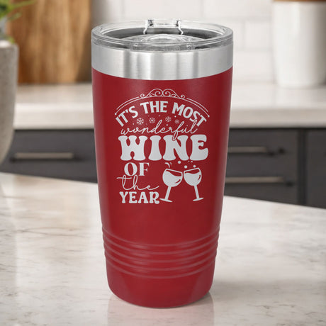 Maroon 20 oz tumbler laser engraved with "It's the Most Wonderful Wine of the Year", on a kitchen counter