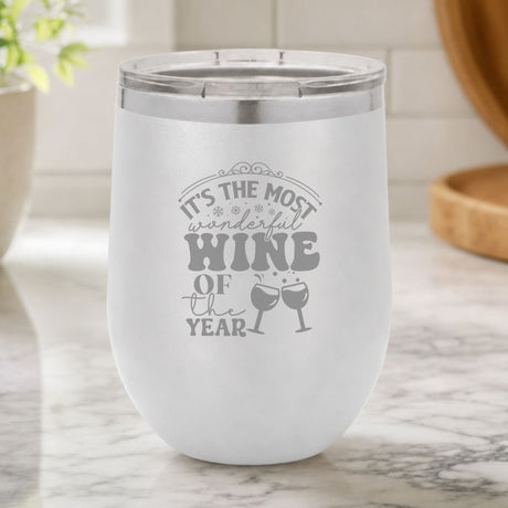 White 12 oz stemless wine tumbler laser engraved with "It's the Most Wonderful Wine of the Year", on a kitchen counter
