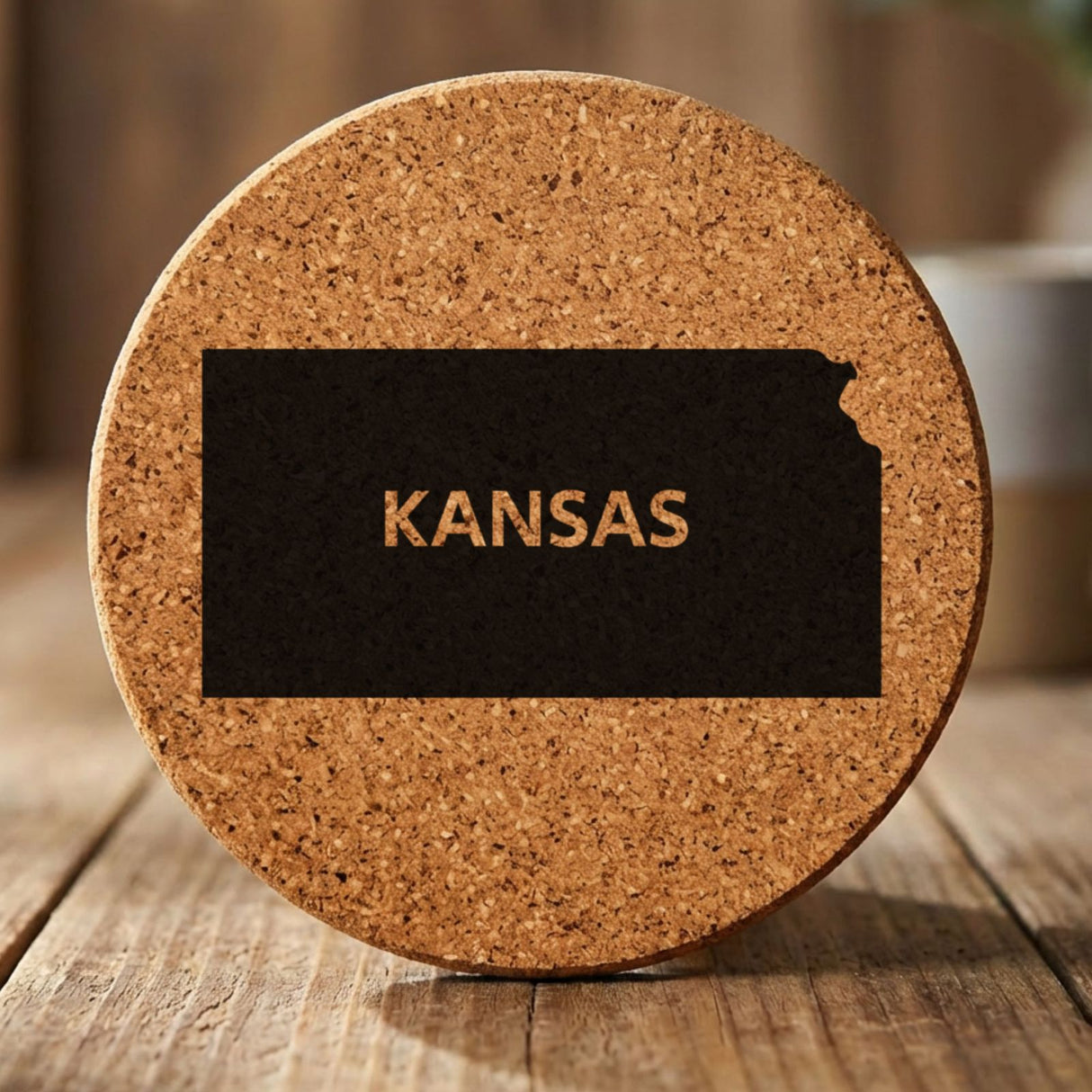 Kansas round cork coaster engraved with the state shape and KANSAS in bold lettering