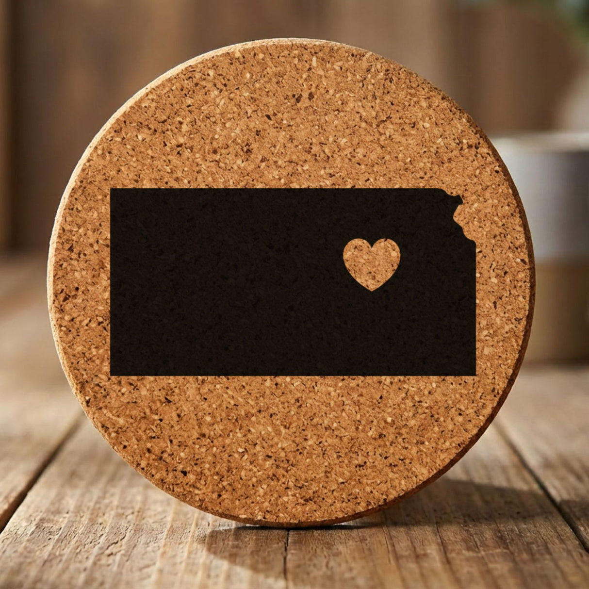Kansas round cork coaster engraved with the state shape and a heart