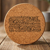 Kansas round cork coaster engraved with a word cloud of repeating Kansas text