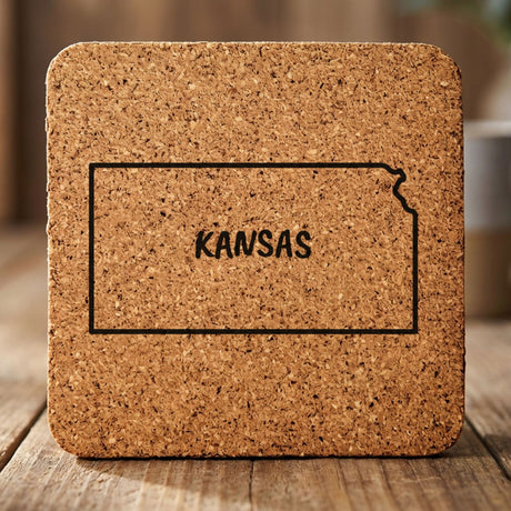 Kansas square cork coaster engraved with the state outline and KANSAS in hand-drawn brush lettering