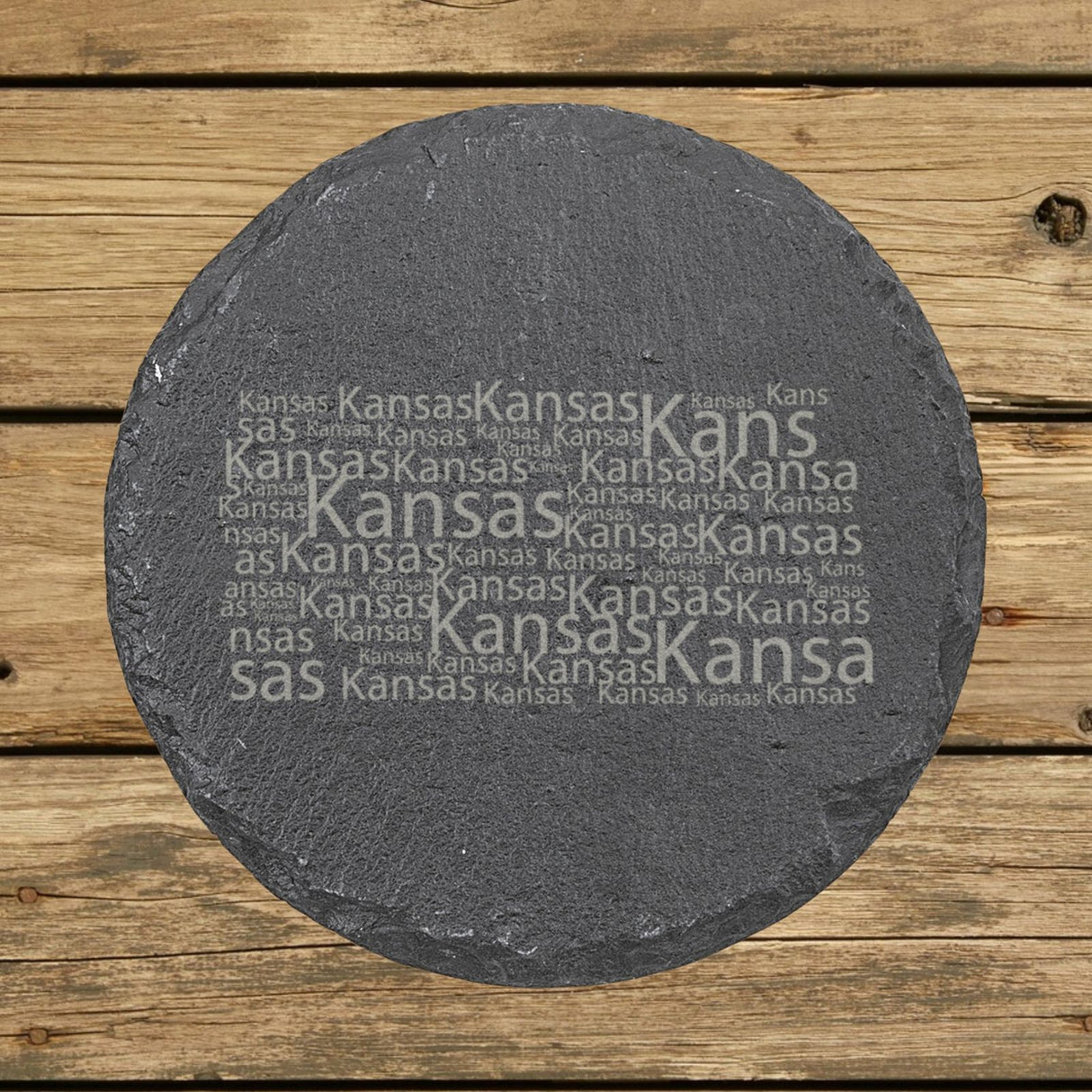 Kansas round slate coaster engraved with a word cloud of repeating Kansas text