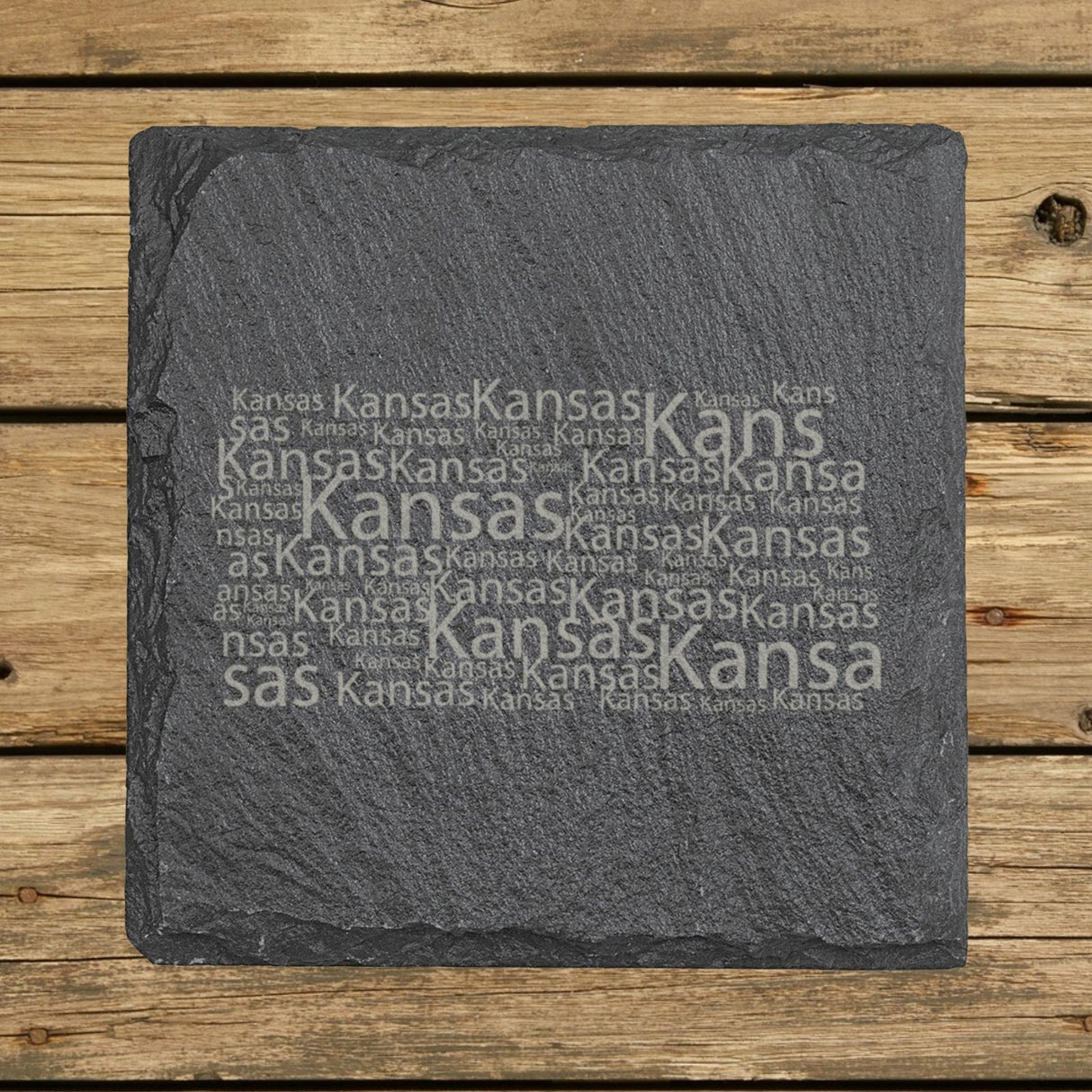 Kansas square slate coaster engraved with a word cloud of repeating Kansas text