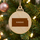 Kansas round wood Christmas ornament engraved with the state shape and KANSAS in bold lettering