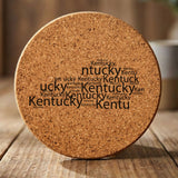 Kentucky round cork coaster engraved with a word cloud of repeating Kentucky text