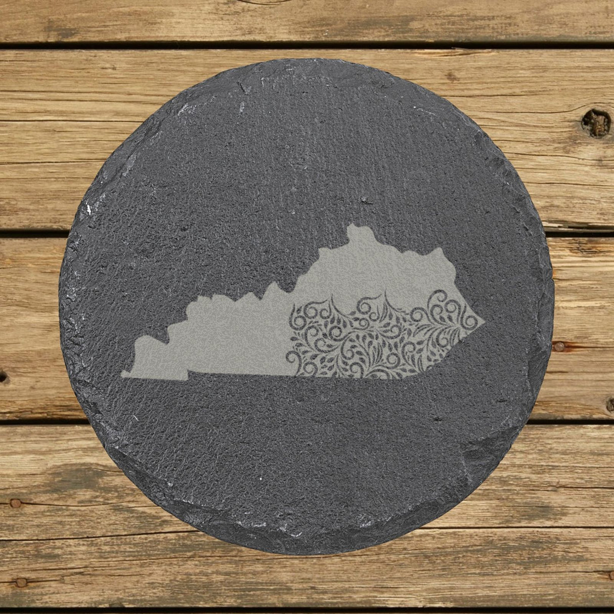 Kentucky round slate coaster engraved with the state shape in ornate floral scrollwork