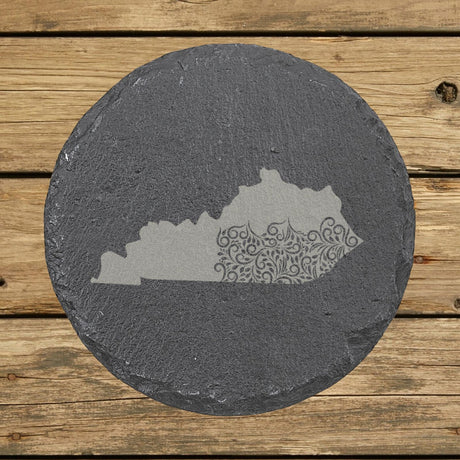 Kentucky round slate coaster engraved with the state shape in ornate floral scrollwork