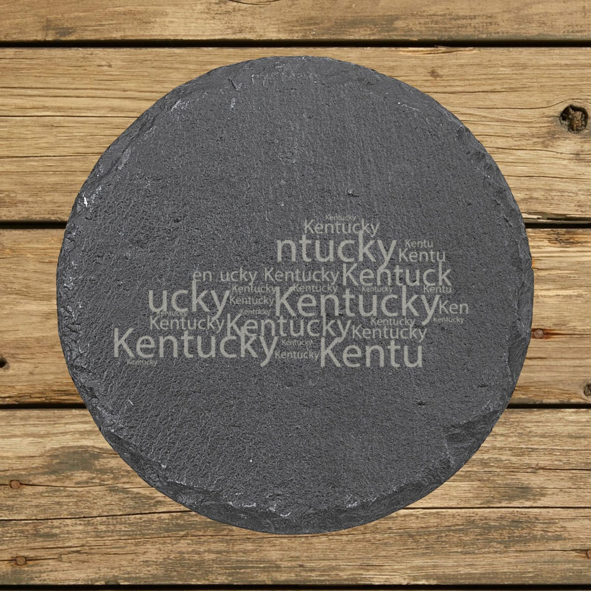 Kentucky round slate coaster engraved with a word cloud of repeating Kentucky text