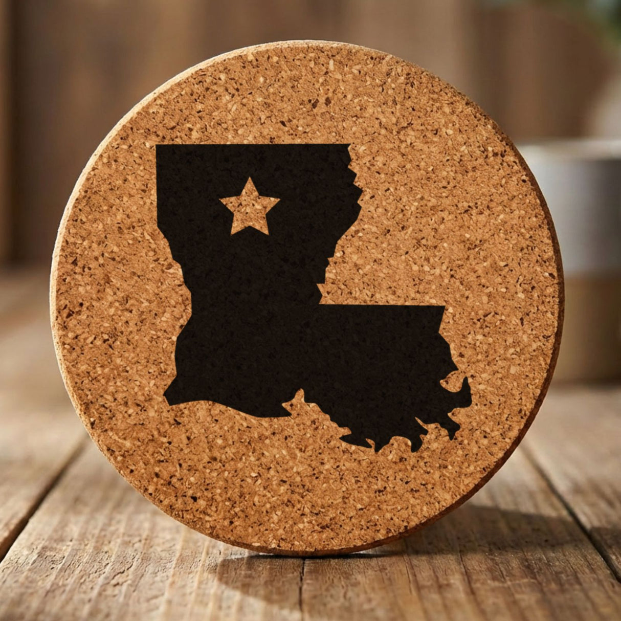 Louisiana round cork coaster engraved with the state shape and a star