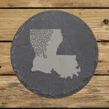Louisiana round slate coaster engraved with the state shape in ornate floral scrollwork