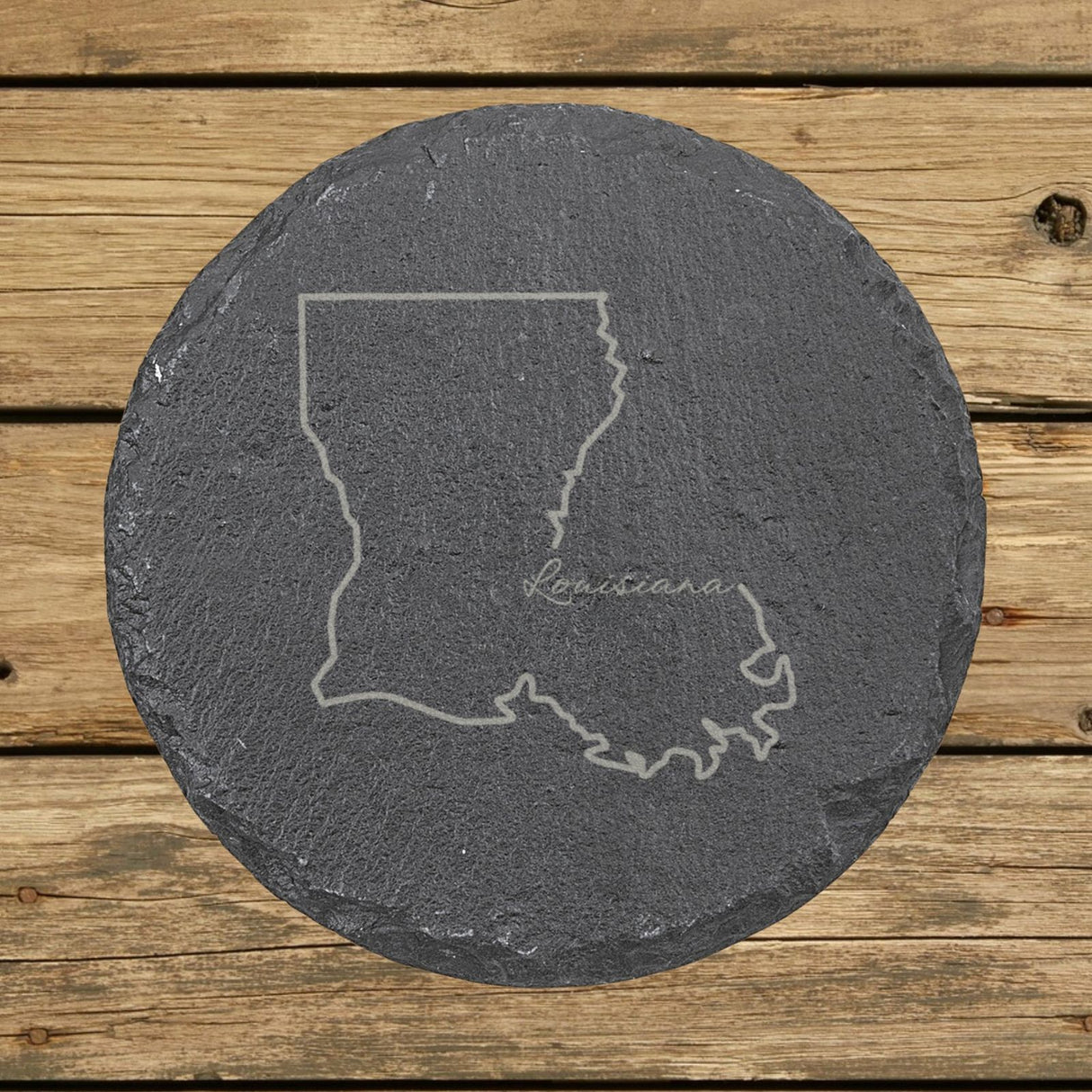 Louisiana round slate coaster engraved with the state outline and Louisiana in script lettering
