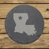 Louisiana round slate coaster engraved with the state shape and a star