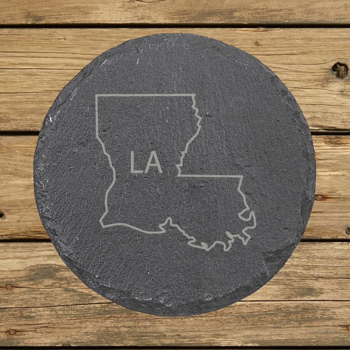 Louisiana round slate coaster engraved with the state outline and LA initials
