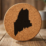Maine round cork coaster with the full state shape engraved