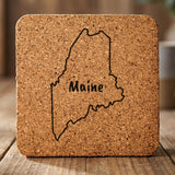 Maine square cork coaster engraved with the state outline and MAINE in hand-drawn brush lettering
