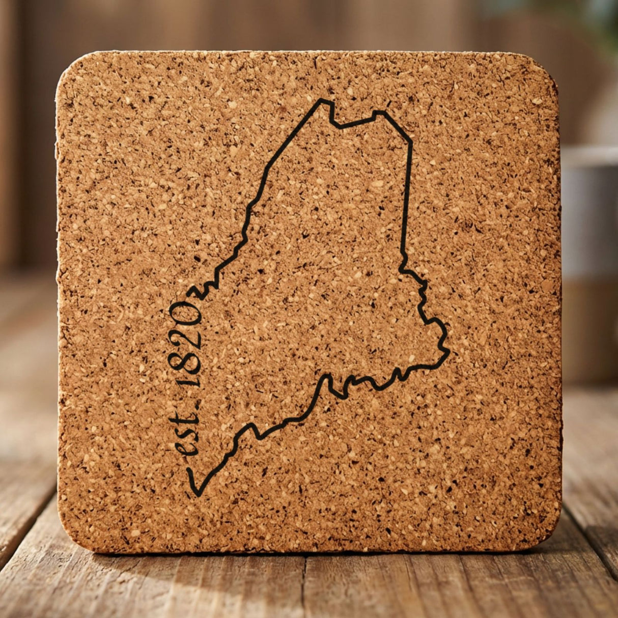 Maine square cork coaster engraved with the state outline and est. 1820