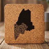 Maine square cork coaster engraved with the state shape in ornate floral scrollwork