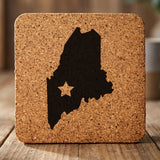Maine square cork coaster engraved with the state shape and a star