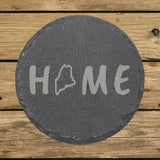 Maine round slate coaster engraved with HOME using the state outline as the letter O
