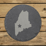 Maine round slate coaster engraved with the state shape and a star