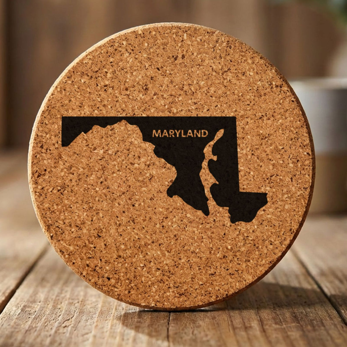 Maryland round cork coaster engraved with the state shape and MARYLAND in bold lettering