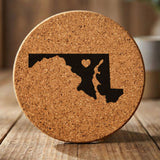 Maryland round cork coaster engraved with the state shape and a heart