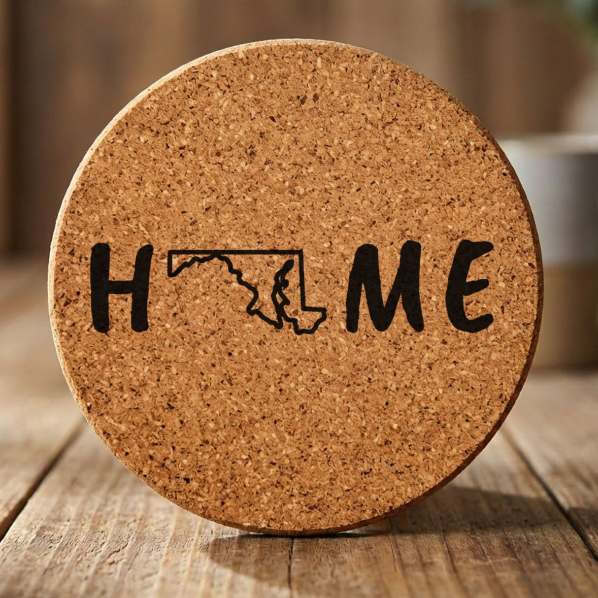 Maryland round cork coaster engraved with HOME using the state outline as the letter O