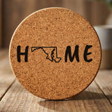 Maryland round cork coaster engraved with HOME using the state outline as the letter O