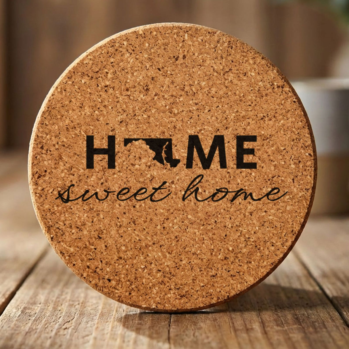 Maryland round cork coaster engraved with HOME sweet home using the state shape as the letter O