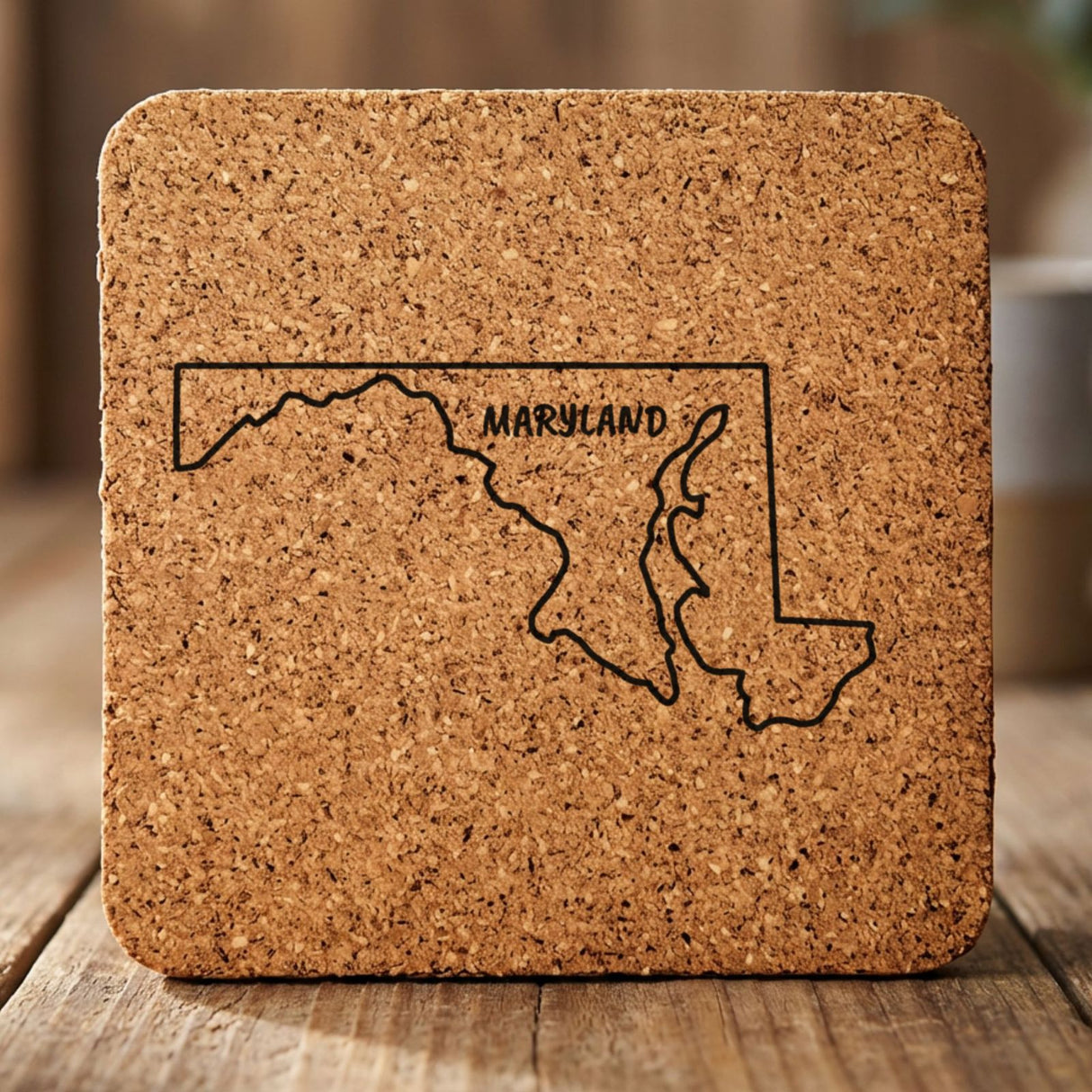 Maryland square cork coaster engraved with the state outline and MARYLAND in hand-drawn brush lettering