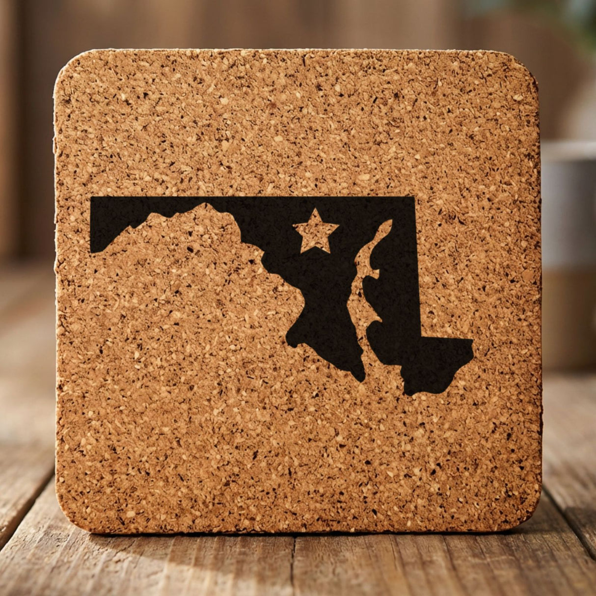 Maryland square cork coaster engraved with the state shape and a star