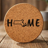Massachusetts round cork coaster engraved with HOME using the state outline as the letter O