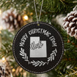Black leatherette round Christmas ornament engraved Merry Christmas From Utah, with the state shape in a laurel wreath, hanging on a tree