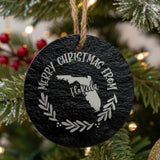 Round slate Christmas ornament engraved Merry Christmas From Florida, with the state shape in a laurel wreath