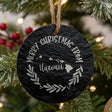 Round slate Christmas ornament engraved Merry Christmas From Hawaii, with the state shape in a laurel wreath