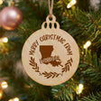 Round wood Christmas ornament engraved Merry Christmas From Louisiana, with the state shape in a laurel wreath