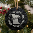 Round slate Christmas ornament engraved Merry Christmas From Minnesota, with the state shape in a laurel wreath