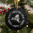 Round slate Christmas ornament engraved Merry Christmas From New York, with the state shape in a laurel wreath