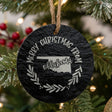 Round slate Christmas ornament engraved Merry Christmas From Oklahoma, with the state shape in a laurel wreath