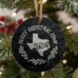 Round slate Christmas ornament engraved Merry Christmas From Texas, with the state shape in a laurel wreath
