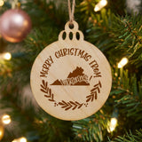 Round wood Christmas ornament engraved Merry Christmas From Virginia, with the state shape in a laurel wreath